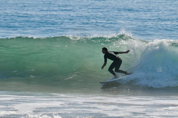 istock Surfer in Silhouette Leans into a Bottom Turn 2038186548