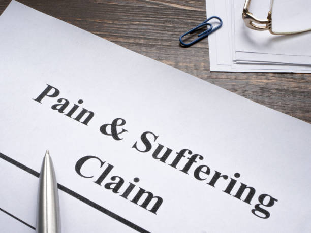 istock Pain and suffering claim with a pen for signing. 2038209677