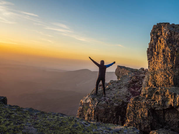 istock Person watching the sunset in the mountains 2038212893