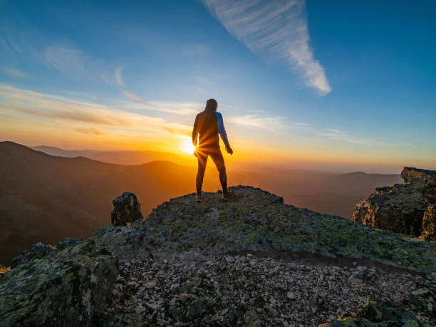istock Person watching the sunset in the mountains 2038212896
