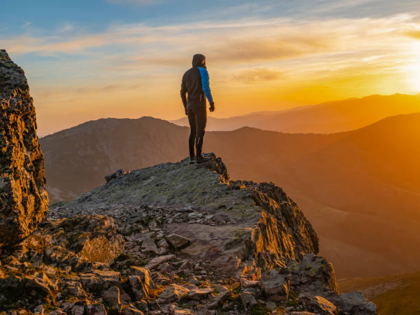 istock Person watching the sunset in the mountains 2038213024