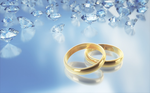 3d Render Gold wedding rings among Diamonds on blue gradient background(Depth Of Field)