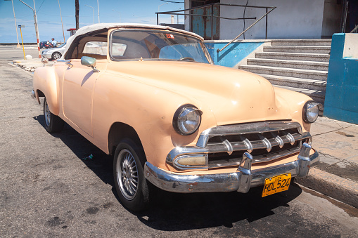 Havana, Cuba - April 12, 2010: A vintage old salmon-pink color Plymouth classic american car parked in Havana, Cuba