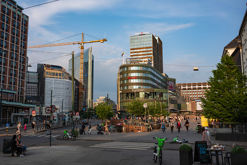 Oslo, Norway, Jun 20, 2023: Street view of downtown Oslo, Norway at sunset with people roaming the city roads near Bishop Gunnerus'street on the Commons.