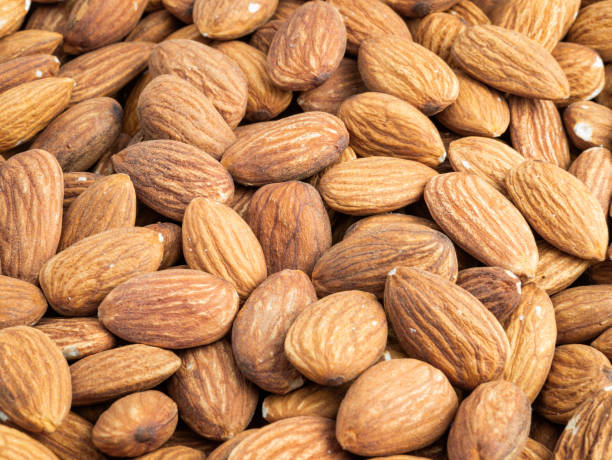 istock Close up with many fresh organic peeled almonds . 2038268905