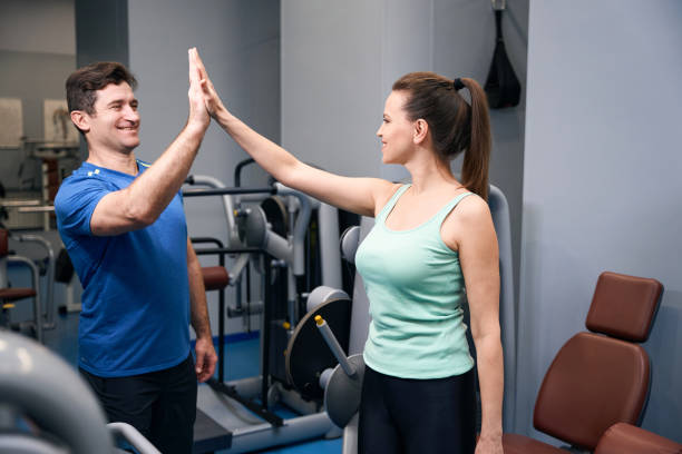 istock Joyous female greeting her fitness instructor before workout 2038269160