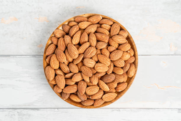 istock Fresh natural healthy almonds nuts on a wooden plate. 2038269441