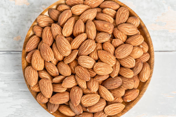 istock Fresh natural healthy almonds nuts on a wooden plate 2038269449