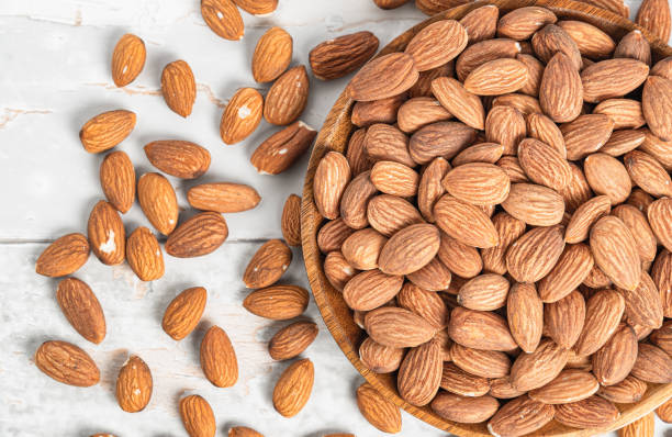 istock Fresh natural healthy almonds nuts on a wooden plate 2038269471