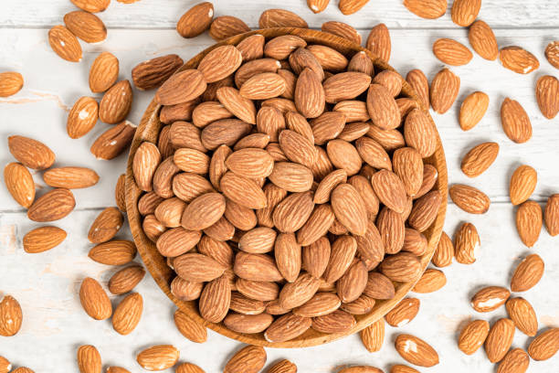istock Fresh natural healthy almonds nuts on a wooden plate. 2038269472