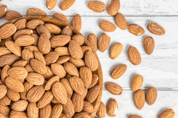 istock Fresh natural healthy almonds nuts on a wooden plate. 2038269483