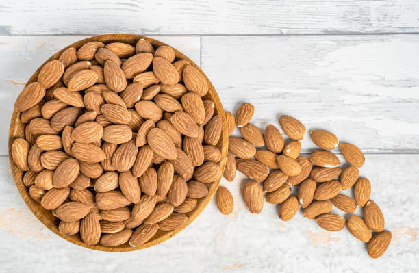 istock Fresh natural healthy almonds nuts on a wooden plate. 2038269510