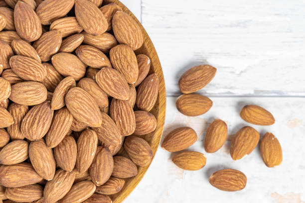 istock Fresh natural healthy almonds nuts on a wooden plate. 2038269515