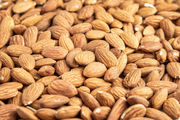 istock Close up with many fresh organic peeled almonds . 2038270044