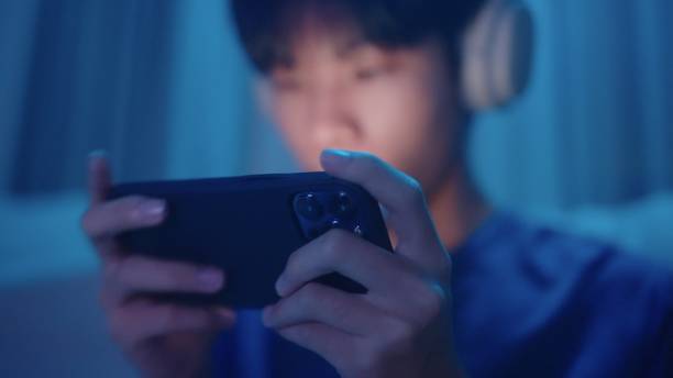 istock Teenage having fun with game on smartphone. 2038295410