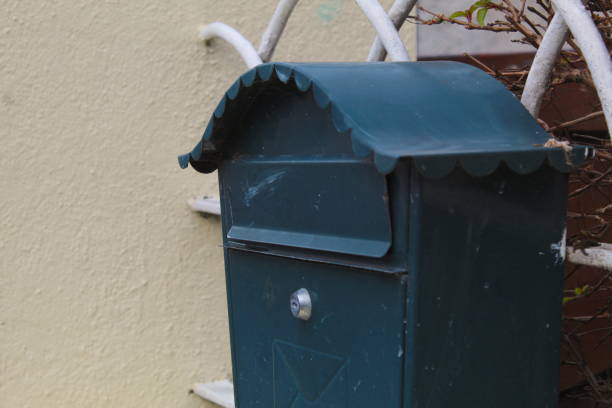 istock Small navy blue letterbox on wall outside house 2038306274