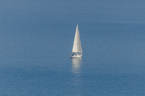 Sailing ship in front of Kornati islands of Croatia blue adriatic sea, green olive trees