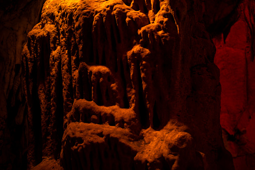 Journey through a vibrant cave adorned with colorful walls, stalactites, and stalagmites, revealing the underground beauty of nature's geological wonders.