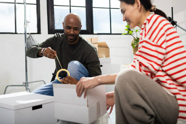 istock Man and his wife packing stuff for moving in 2038309531