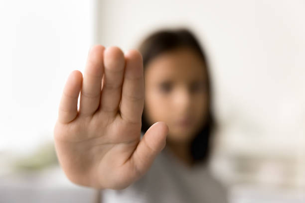 istock Scared kid making hand stop gesture, showing palm at camera 2038321370