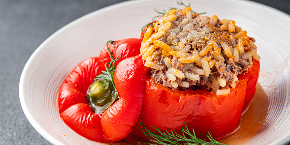 Halved bell pepper stuffed with minced white meat and carrot stuffing and baked in oven. Only vegetables and proteins, no other carbs. Hay diet, keto diet.