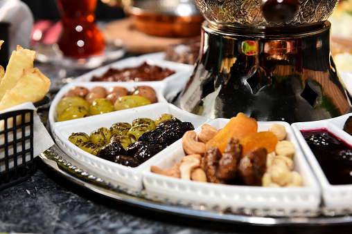 Tea from a samovar with a olives, dry fruits and jam