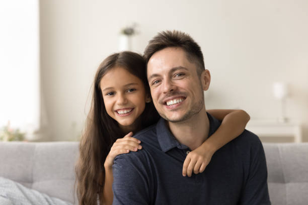 istock Happy handsome dad and cheerful girl looking at camera 2038343330