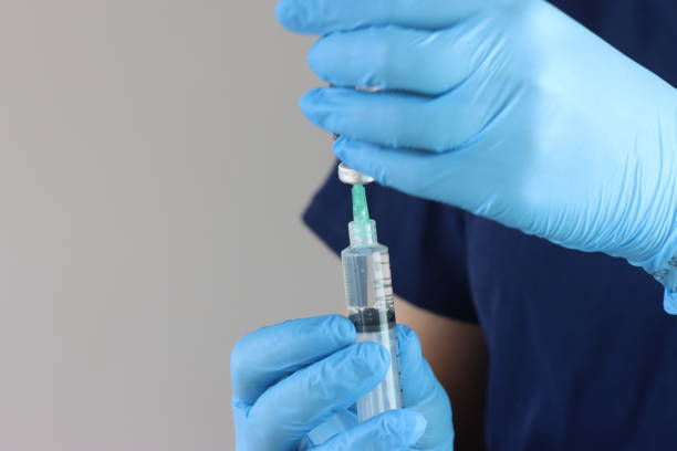 istock Professional wearing gloves snorting drug from a vial with a syringe 2038343377