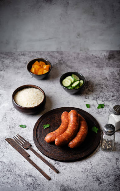 istock Raw uncooked sausages Chorizo on a wood board 2038343675