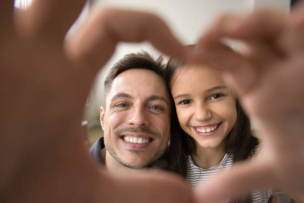 istock Cheerful girl kid and happy young dad making finger frame 2038374555