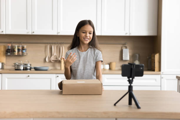 istock Positive blogger kid shooting review on purchase from Internet store 2038375607