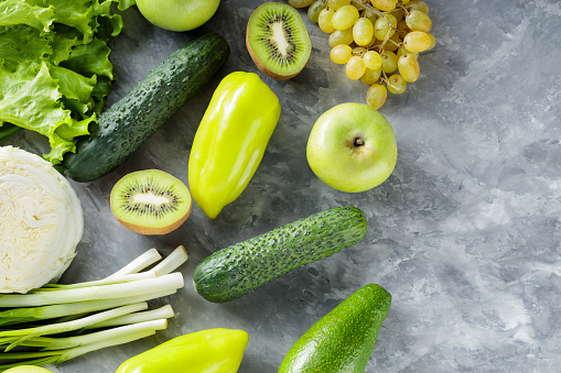 Fresh Green Vegetables and Fruits on Concrete Surface, Top View