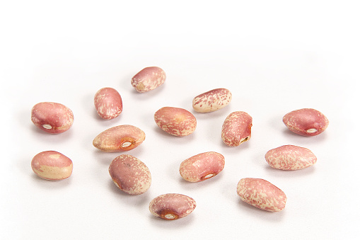Pile of raw kidney beans, pinto beans isolated on white background, healthy food concept