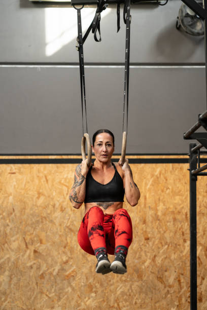 istock Woman training with olympic rings in a cross training center 2038439183