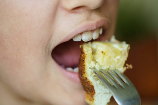 istock Crop anonymous young girl eating delicious potato omelette 2038440817
