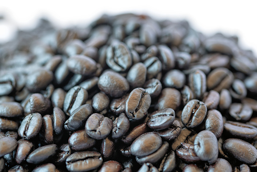 Medium roasted coffee beans on white background