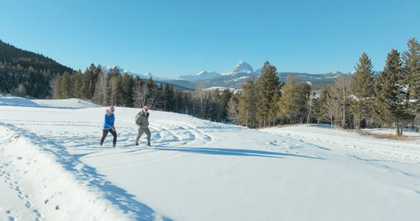istock Mature couple hike in snowy winter landscape 2038456821