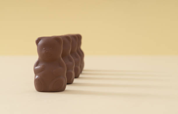Close-up image of a teddy bear's face adorned with round glasses, showcasing its soft texture and endearing expression, captured with a clear background for emphasis.
