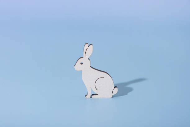 istock Wooden rabbit symbol for Easter on a blue background 2038496320