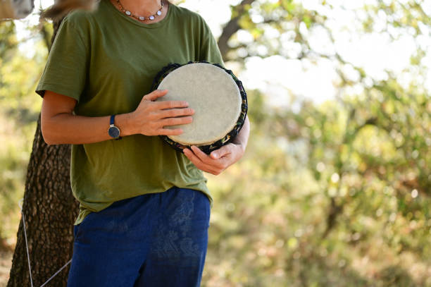 woman holding the drum. African djembe. healing sound treatment. African djembe. guiro stock pictures, royalty-free photos & images