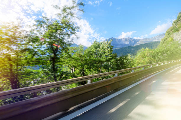 Mountain landscape with view from the highway - French Alps clear blue sky with some scattered clouds