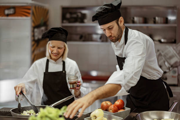 istock Male and Female Chefs Cooking in a Modern Professional Kitchen 2038547311