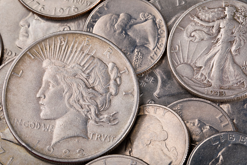 Different types of U.S. silver coins background.