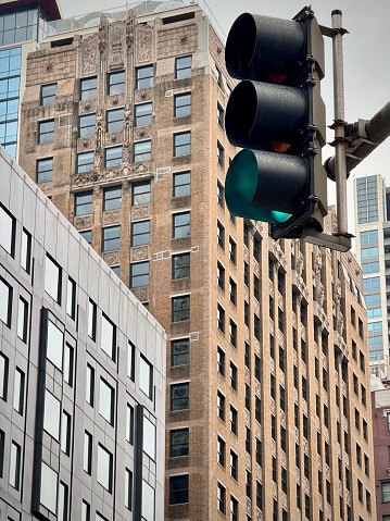 urban landscape of downtown Chicago with a low angle view of city buildings with a traffic light