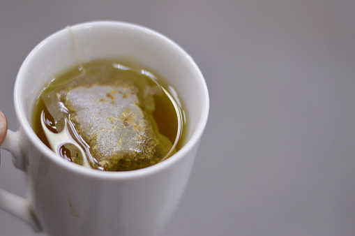 Anise hot drink, with so many healthy benefits, anise packet in a boiled hot water to prepare the drink, Aniseed Pimpinella anisum is a flowering plant in the family Apiaceae, selective focus