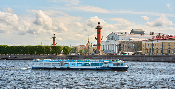 Saint Isaac's Cathedral and Spit of Vasilievsky Island seen from Neva river. Dramatic rainy clouds on the background. St. Petersburg