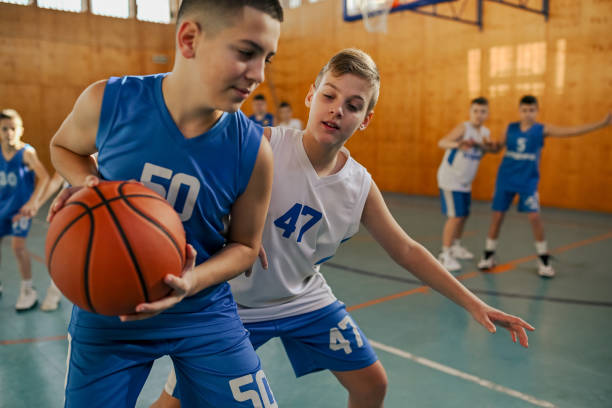 istock Junior basketball player practicing basketball on court during training. 2038749882
