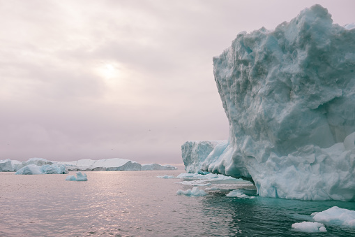 A collection of massive icebergs from the Icefjord in Illulisat, Greenland.  Image taken from a small boat.