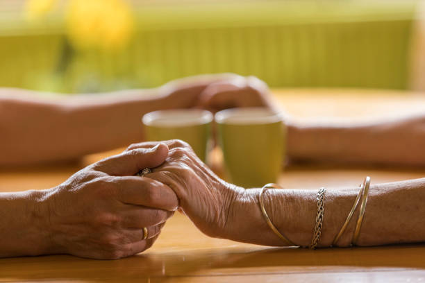 A man and a woman holding each other's hands, a pair of holding hands