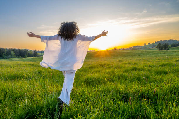 istock Woman with spread hands running in field 2038818498